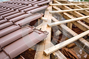 Symmetric distribution of roof tiles on new house construction site