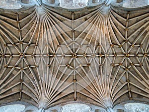 The symmetrical detail of the vaulted ceiling and ornate bosses in Norwich Cathedral, Norfolk, UK