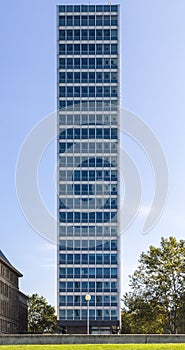 Symmetrical front shoot of an office building with blue sky from