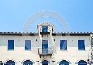 Symmetrical order of blue windows and door on exterior wall