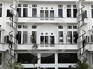 Symmetrical vintage building in black and white attached with spiral stairs