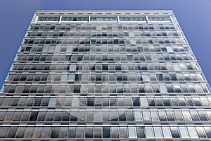 Symmetrically background of gray sunshades facade modern office building