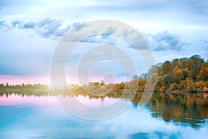 Symmetry reflection on the autumn river. Sunrise.