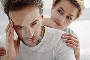Sympathetic woman supporting her husband in difficult situation