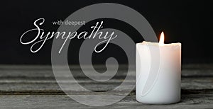 Sympathy card. Memorial candle on wooden background