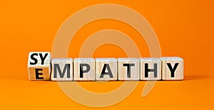 Sympathy or empathy symbol. Turned wooden cubes and changed the concept word Empathy to Sympathy. Beautiful orange table orange
