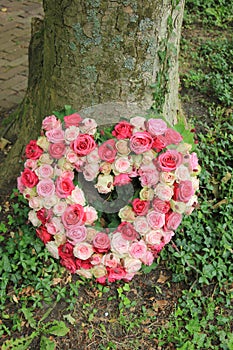 Sympathy flowers near a tree