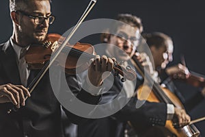 Symphonic string orchestra performing on stage