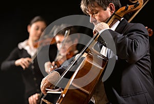 Symphony orchestra performance: celloist close-up photo