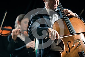 Symphony orchestra performance: celloist close-up photo