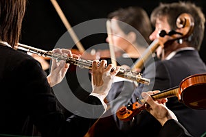 Symphony orchestra performance: flutist close-up photo