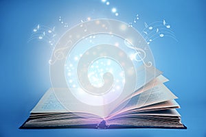 Symphony shining with musical notes from open book on background