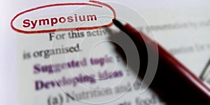 symposium biological word written on english language with red colour covering text form