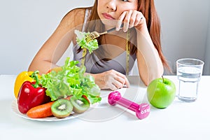 Symptoms of anorexia manifested in aversion to food. Portrait of young Asian woman in unsatisfied facial emotional expression,