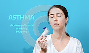 Symptoms of asthma. Portrait of sad young woman holding inhaler. Blue background. Text