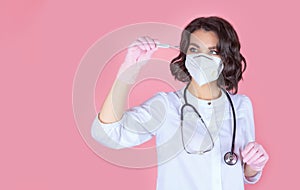 Symptoms of coronavirus, a female doctor in a medical mask measures body temperature