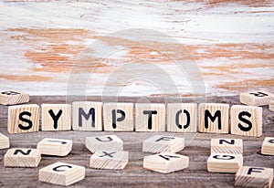 Symptoms from wooden letters on wooden background