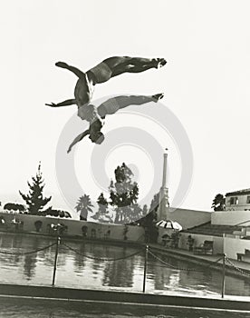 Synchronized divers in mid-air photo