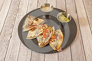 Synchronized Mexican Quesadillas Stuffed with Cheese with Cooked Ham and Cream Cheese, Pico de Gallo and Guacamole photo