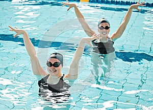 Synchronized, women and competition in swimming pool performance, event or dance together in water or sport. Athlete
