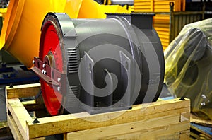Synchronous traction generator with a cylindrical rotor in the production hall of an automobile plant. Electrical engines and