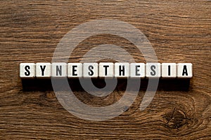 Synesthesia - word concept on building blocks, text