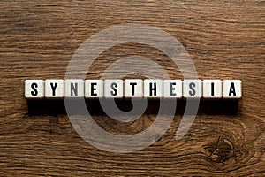 Synesthesia - word concept on building blocks, text photo