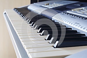 A synthesizer or electronic piano keys. Musical education for kid in music school