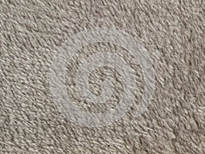 Synthetic fur gray texture for the background. Light natural sheep wool. Detail fragment dark wool carpet. Hairy substance as back