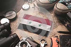 Syria Flag Between Traveler`s Accessories on Old Vintage Map. Tourist Destination Concept photo