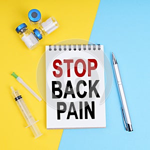 A syringe, ampoules and a notebook with the inscription - STOP BACK PAIN