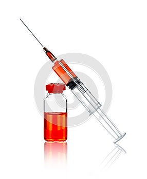 Syringe and ampule with a red substance on the