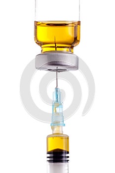 Syringe beeing filled with yellow liquid from medicin vial