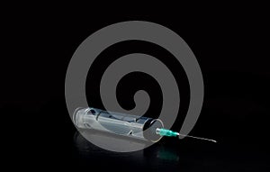 Syringe on black background