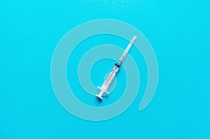 Syringe on a blue background