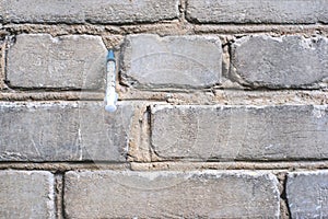 Syringe in brick wall. Health and medicine.