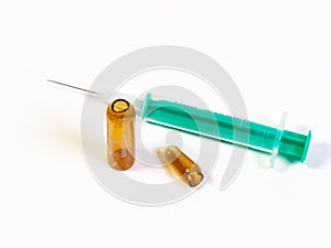 A syringe and a broken ampule on white background