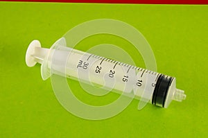 Syringe closeup isolated on colred background