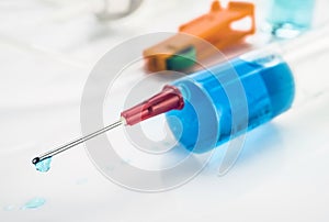 Syringe with drop of medication in the needle