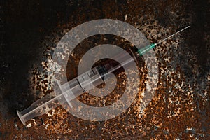 Syringe and drugs on dirty rusty background. Injection syringe. addiction