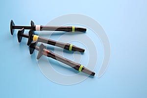 Syringe of esthetic filling material on color background