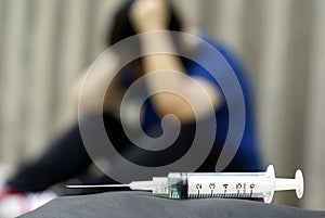 Syringe and female in anguish photo