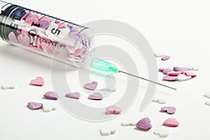 Syringe filled with heart shaped candy