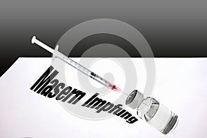 Syringe is filled with vaccine for measles vaccination.