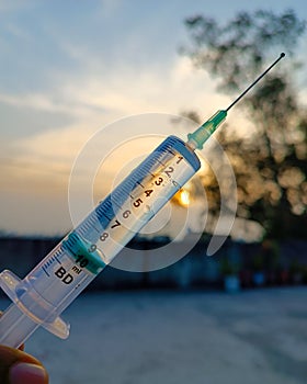 syringe filled with water with blur background