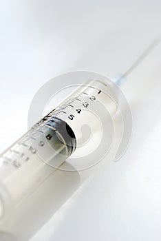 Syringe with hypodermic needle isolated on white photo