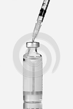 Syringe injected into insulin vial.