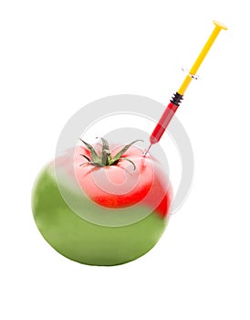 Syringe Injecting Red Liquid Into a Green Tomato photo