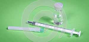 Syringe injection or medical needle isolated on green