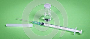 Syringe injection or medical needle isolated on green